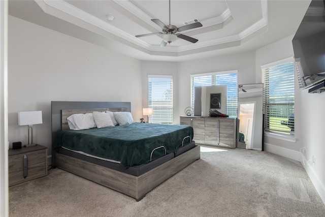 2736 Ahnya Ln, League City, TX 77573 - bedroom featuring crown molding, a tray ceiling, light carpet, a ceiling fan, and baseboards