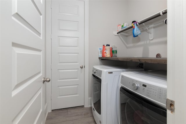 2736 Ahnya Ln, League City, TX 77573 - clothes washing area featuring washing machine and clothes dryer and light wood-style flooring