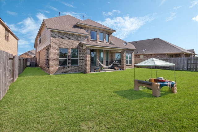 2736 Ahnya Ln, League City, TX 77573 - back of house with brick siding, a shingled roof, cooling unit, and a patio area
