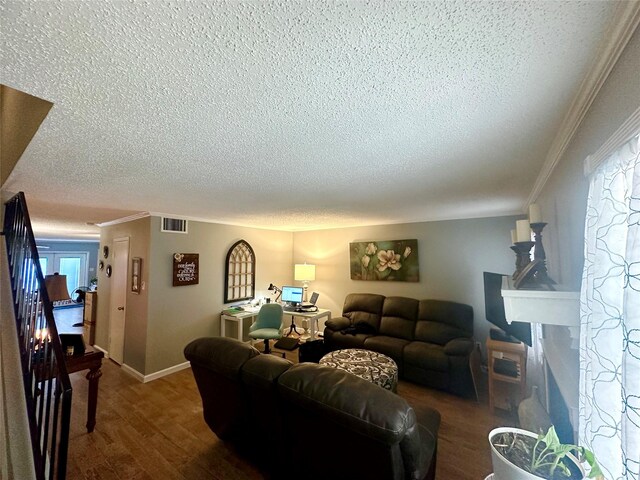 6452 Kentwick Dr, Houston, TX 77084 - living room with visible vents, a textured ceiling, ornamental molding, and dark wood-style floors