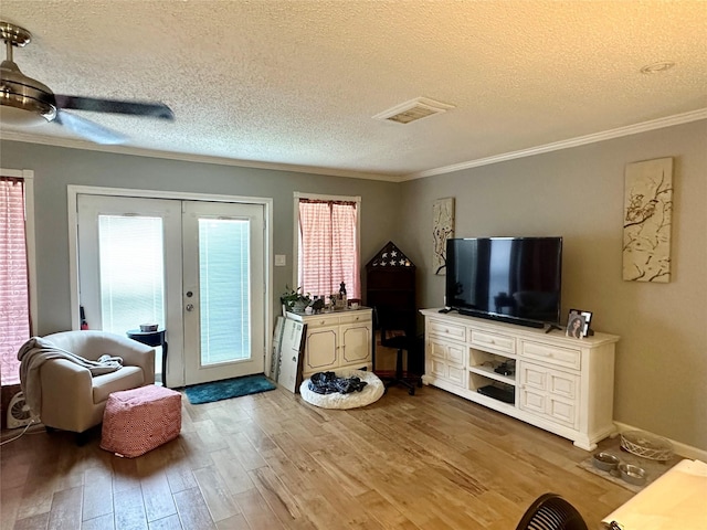 6452 Kentwick Dr, Houston, TX 77084 - living room featuring french doors, crown molding, wood finished floors, and a textured ceiling