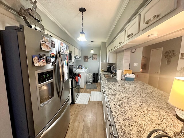6452 Kentwick Dr, Houston, TX 77084 - kitchen featuring light wood-type flooring, white cabinetry, ornamental molding, a sink, and stainless steel appliances