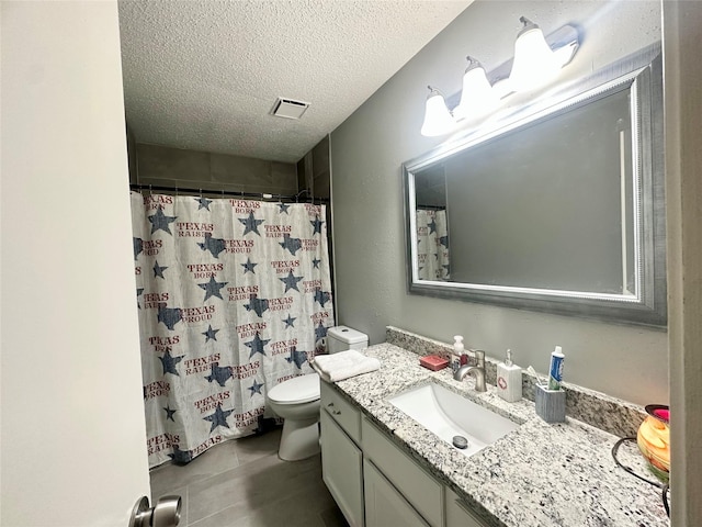 6452 Kentwick Dr, Houston, TX 77084 - full bathroom featuring vanity, tile patterned flooring, a textured ceiling, toilet, and visible vents