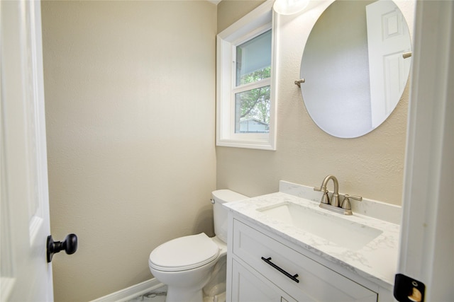 half bathroom with toilet and vanity