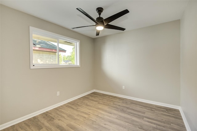 empty room with light wood-type flooring, ceiling fan, and baseboards