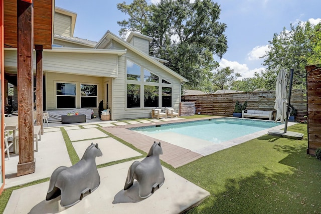 view of pool featuring a yard, fence, a fenced in pool, and a patio