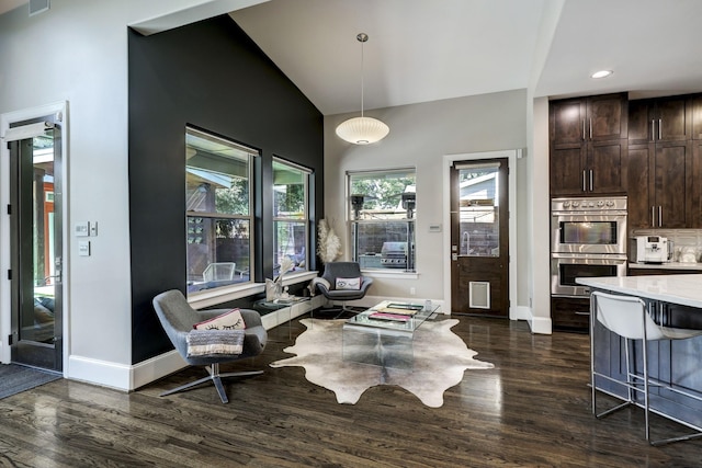living area featuring high vaulted ceiling, recessed lighting, dark wood-type flooring, and baseboards
