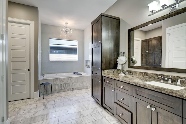 bathroom featuring a chandelier, vanity, a bath, and marble finish floor