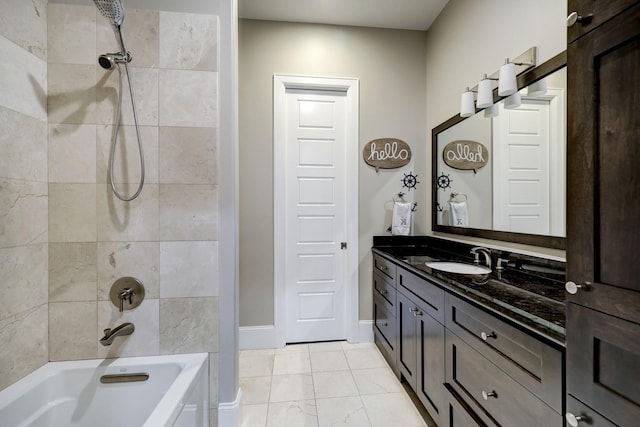 bathroom with bathing tub / shower combination, vanity, baseboards, and marble finish floor