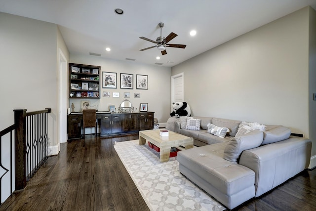 living room featuring dark wood-type flooring, a ceiling fan, visible vents, and recessed lighting