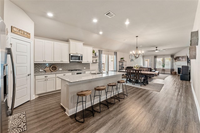 21718 Rose Maris Ln, Tomball, TX 77377 - kitchen featuring appliances with stainless steel finishes, white cabinetry, backsplash, dark wood finished floors, and a sink