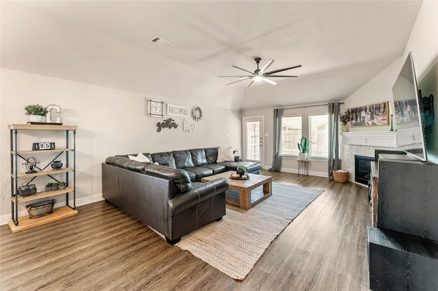 21718 Rose Maris Ln, Tomball, TX 77377 - living area with visible vents, a ceiling fan, wood finished floors, a glass covered fireplace, and lofted ceiling