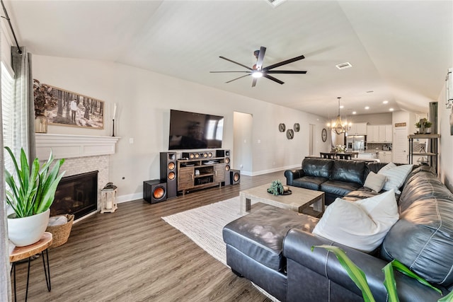 21718 Rose Maris Ln, Tomball, TX 77377 - living area featuring ceiling fan with notable chandelier, baseboards, and lofted ceiling