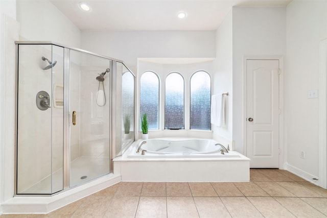 full bath with recessed lighting, tile patterned floors, a shower stall, and a garden tub