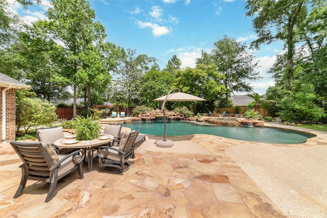 view of pool featuring a fenced backyard, a patio area, and a pool with connected hot tub