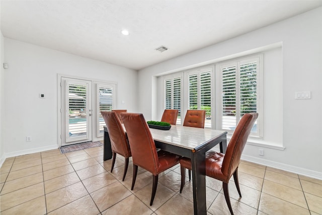 dining room featuring visible vents, baseboards, and a wealth of natural light