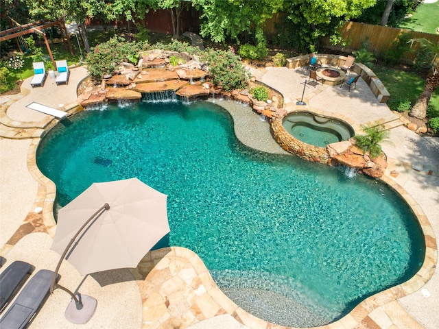 view of pool with a fire pit, a patio, a fenced backyard, a fenced in pool, and an in ground hot tub
