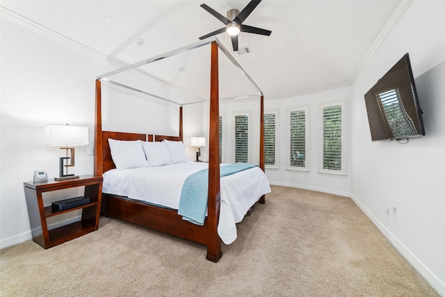 carpeted bedroom with crown molding, baseboards, and ceiling fan