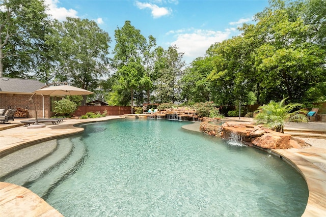 outdoor pool with a patio area and fence