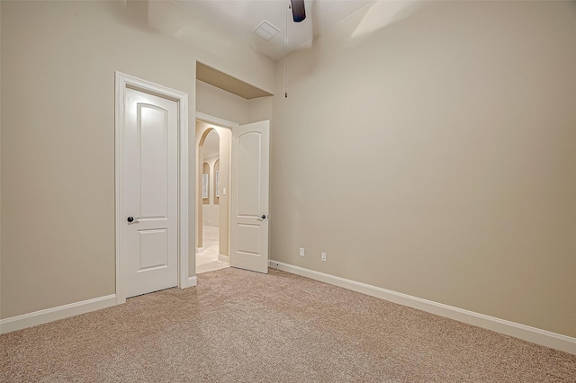 3215 Wimberly Place Ln, Katy, TX 77494 - unfurnished bedroom featuring light colored carpet, arched walkways, baseboards, and ceiling fan