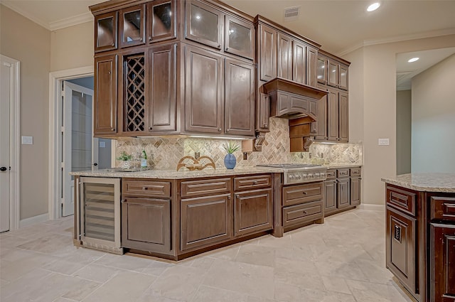3215 Wimberly Place Ln, Katy, TX 77494 - kitchen featuring beverage cooler, stainless steel gas stovetop, ornamental molding, tasteful backsplash, and light stone countertops