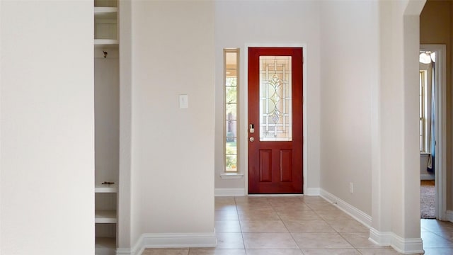 2135 Llerena Ln, League City, TX 77573 - foyer entrance featuring arched walkways, light tile patterned floors, and baseboards