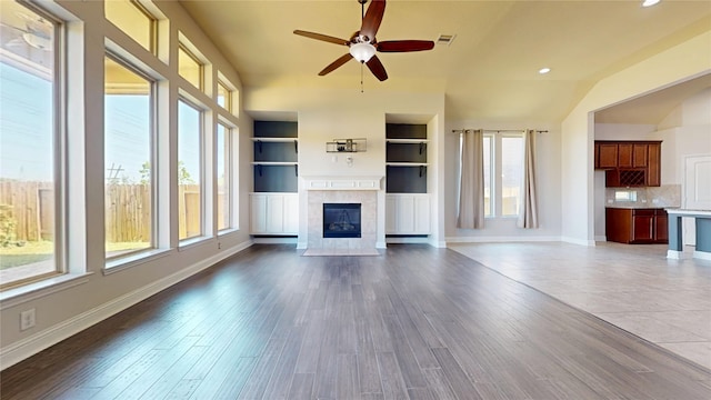 2135 Llerena Ln, League City, TX 77573 - unfurnished living room featuring a fireplace, healthy amount of natural light, ceiling fan, baseboards, and recessed lighting