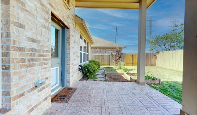 2135 Llerena Ln, League City, TX 77573 - fenced backyard featuring a vegetable garden and a patio area