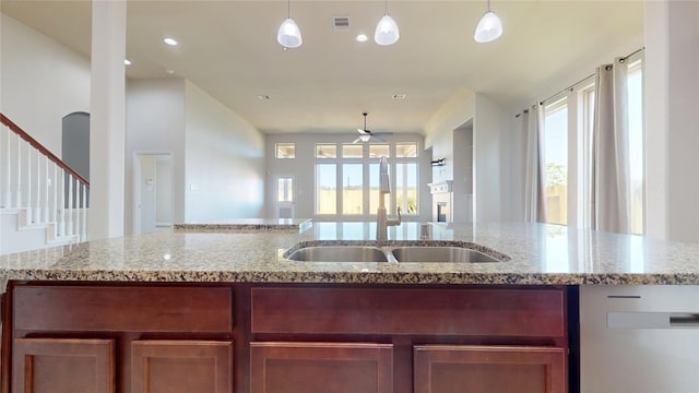2135 Llerena Ln, League City, TX 77573 - kitchen featuring ceiling fan, open floor plan, a sink, pendant lighting, and light stone countertops
