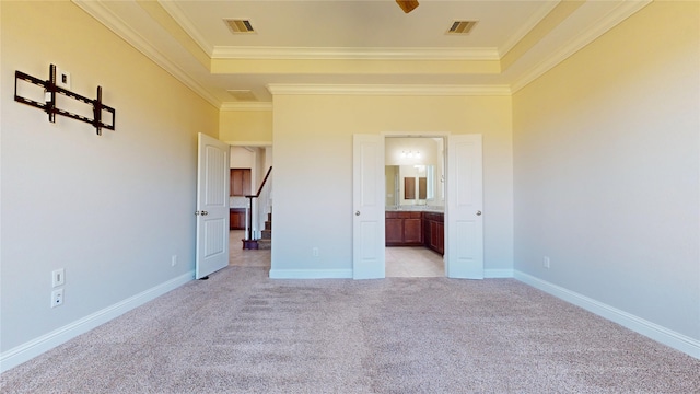 2135 Llerena Ln, League City, TX 77573 - unfurnished bedroom featuring light carpet, crown molding, a raised ceiling, connected bathroom, and baseboards