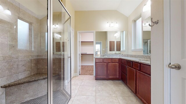 2135 Llerena Ln, League City, TX 77573 - full bath featuring a stall shower, double vanity, vaulted ceiling, tile patterned flooring, and a spacious closet