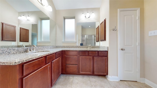 2135 Llerena Ln, League City, TX 77573 - bathroom featuring double vanity, a shower stall, baseboards, and tile patterned flooring