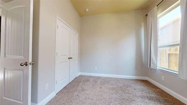 2135 Llerena Ln, League City, TX 77573 - unfurnished bedroom featuring carpet, multiple windows, baseboards, and a closet