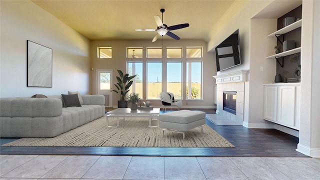 2135 Llerena Ln, League City, TX 77573 - living room with a ceiling fan, a fireplace, baseboards, and wood finished floors