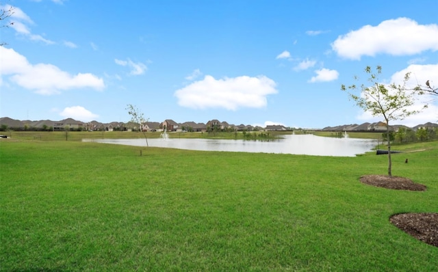 view of home's community featuring a lawn, a water view, and a residential view