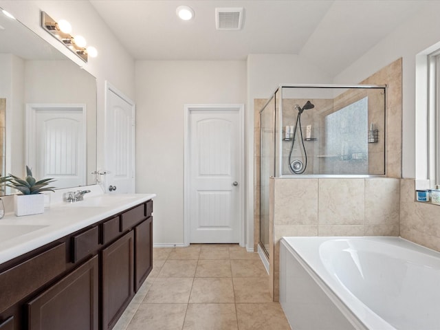 bathroom featuring visible vents, a sink, a shower stall, a garden tub, and double vanity