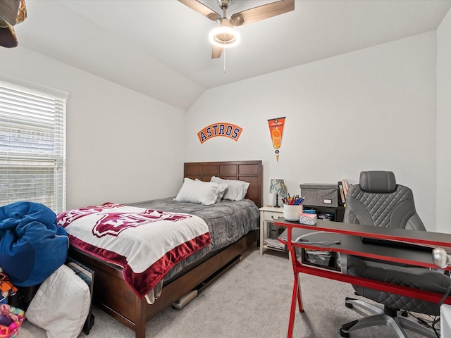 bedroom with ceiling fan, lofted ceiling, and carpet flooring