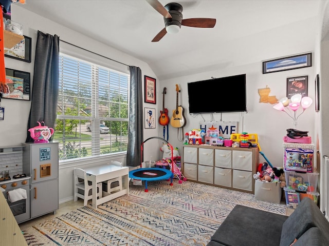 game room featuring a ceiling fan, baseboards, and vaulted ceiling