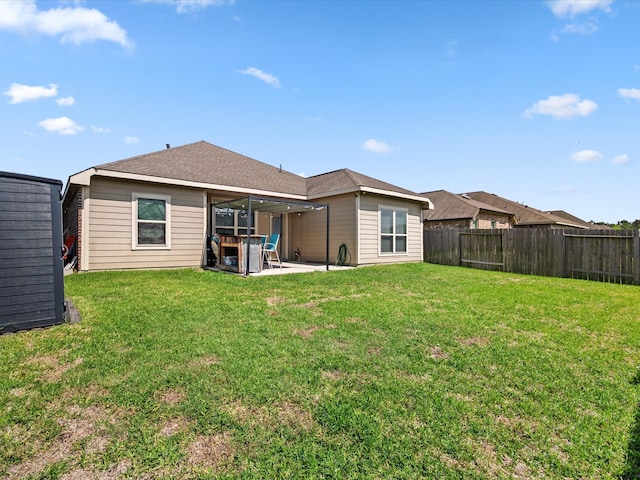 rear view of property with a patio area, a lawn, and a fenced backyard
