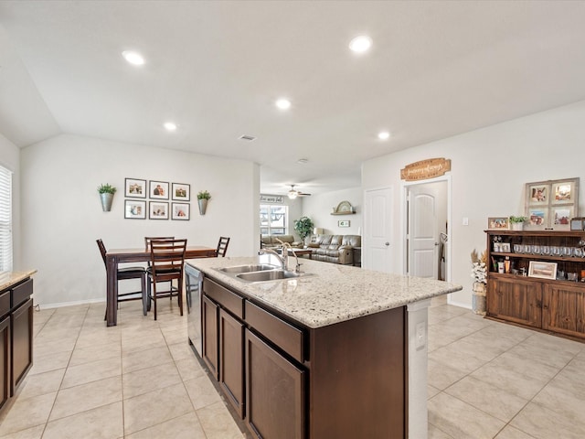 kitchen with recessed lighting, dishwasher, light tile patterned flooring, dark brown cabinetry, and a sink