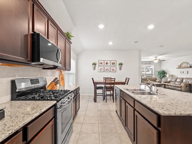 kitchen featuring a wealth of natural light, appliances with stainless steel finishes, decorative backsplash, and a sink