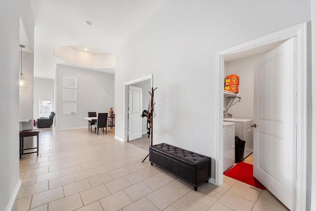 4430 Painted Bunting Ln, Baytown, TX 77521 - hallway with baseboards, washing machine and clothes dryer, and light tile patterned flooring