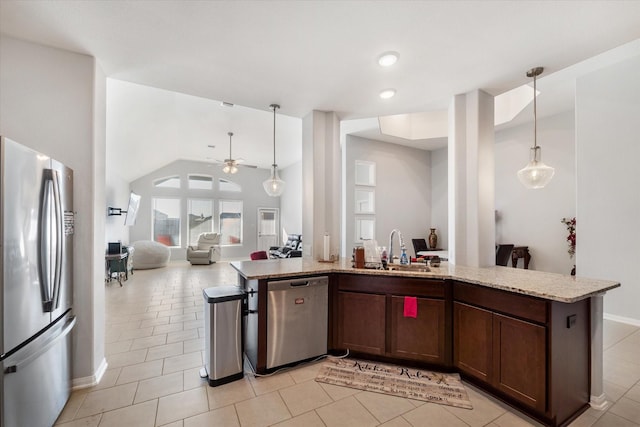 4430 Painted Bunting Ln, Baytown, TX 77521 - kitchen featuring ceiling fan, appliances with stainless steel finishes, light stone counters, a sink, and open floor plan