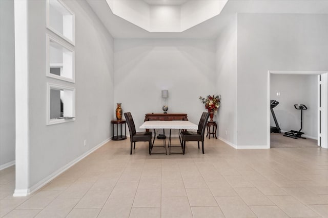 4430 Painted Bunting Ln, Baytown, TX 77521 - dining space featuring light tile patterned floors, baseboards, and a towering ceiling