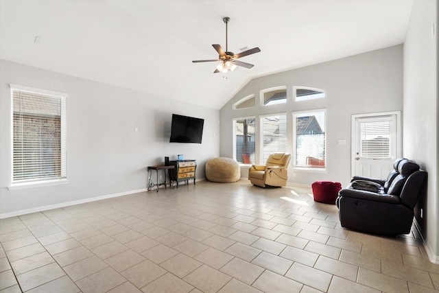4430 Painted Bunting Ln, Baytown, TX 77521 - living area with light tile patterned floors, ceiling fan, high vaulted ceiling, and baseboards
