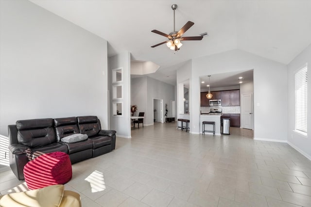 4430 Painted Bunting Ln, Baytown, TX 77521 - living area featuring light tile patterned floors, ceiling fan, vaulted ceiling, and baseboards