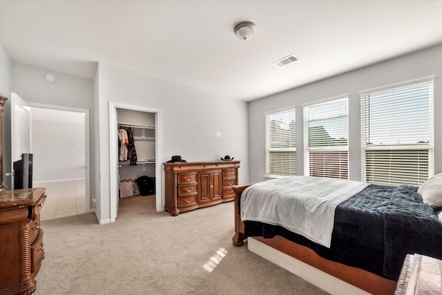4430 Painted Bunting Ln, Baytown, TX 77521 - bedroom featuring visible vents, a spacious closet, a closet, and light carpet