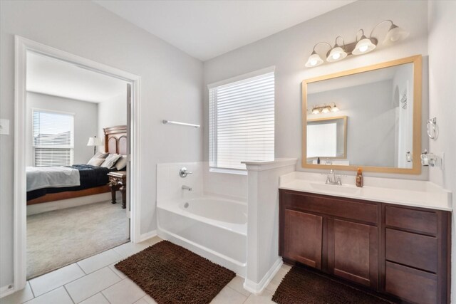 4430 Painted Bunting Ln, Baytown, TX 77521 - ensuite bathroom with tile patterned floors, vanity, a bath, and connected bathroom