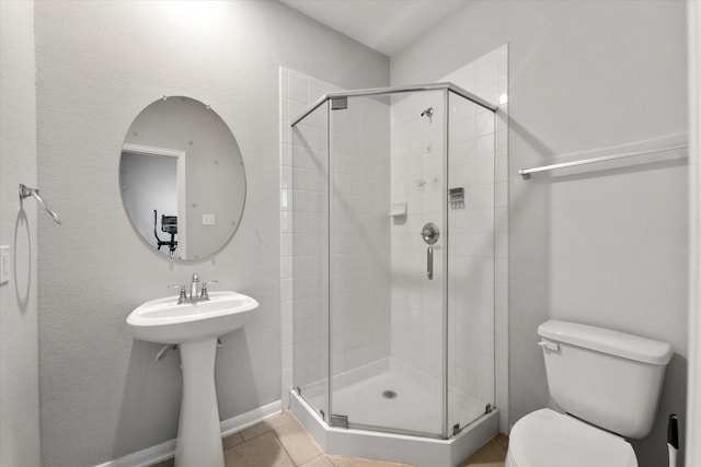 4430 Painted Bunting Ln, Baytown, TX 77521 - full bathroom with toilet, baseboards, a stall shower, and tile patterned flooring