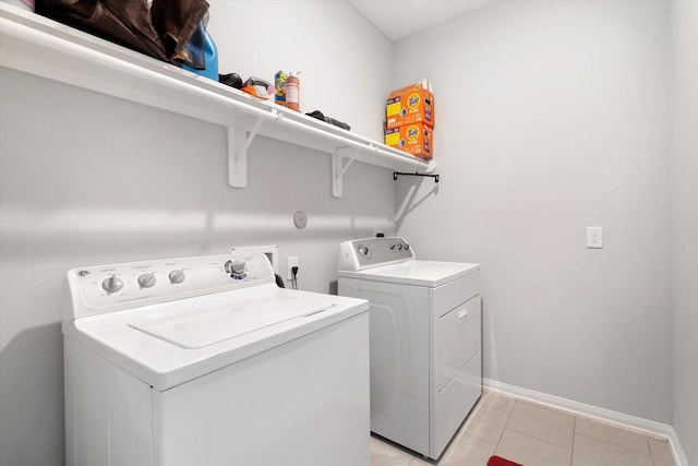 4430 Painted Bunting Ln, Baytown, TX 77521 - laundry room featuring washer and clothes dryer, laundry area, baseboards, and light tile patterned flooring